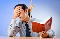 Businessman reading bible before hanging himself